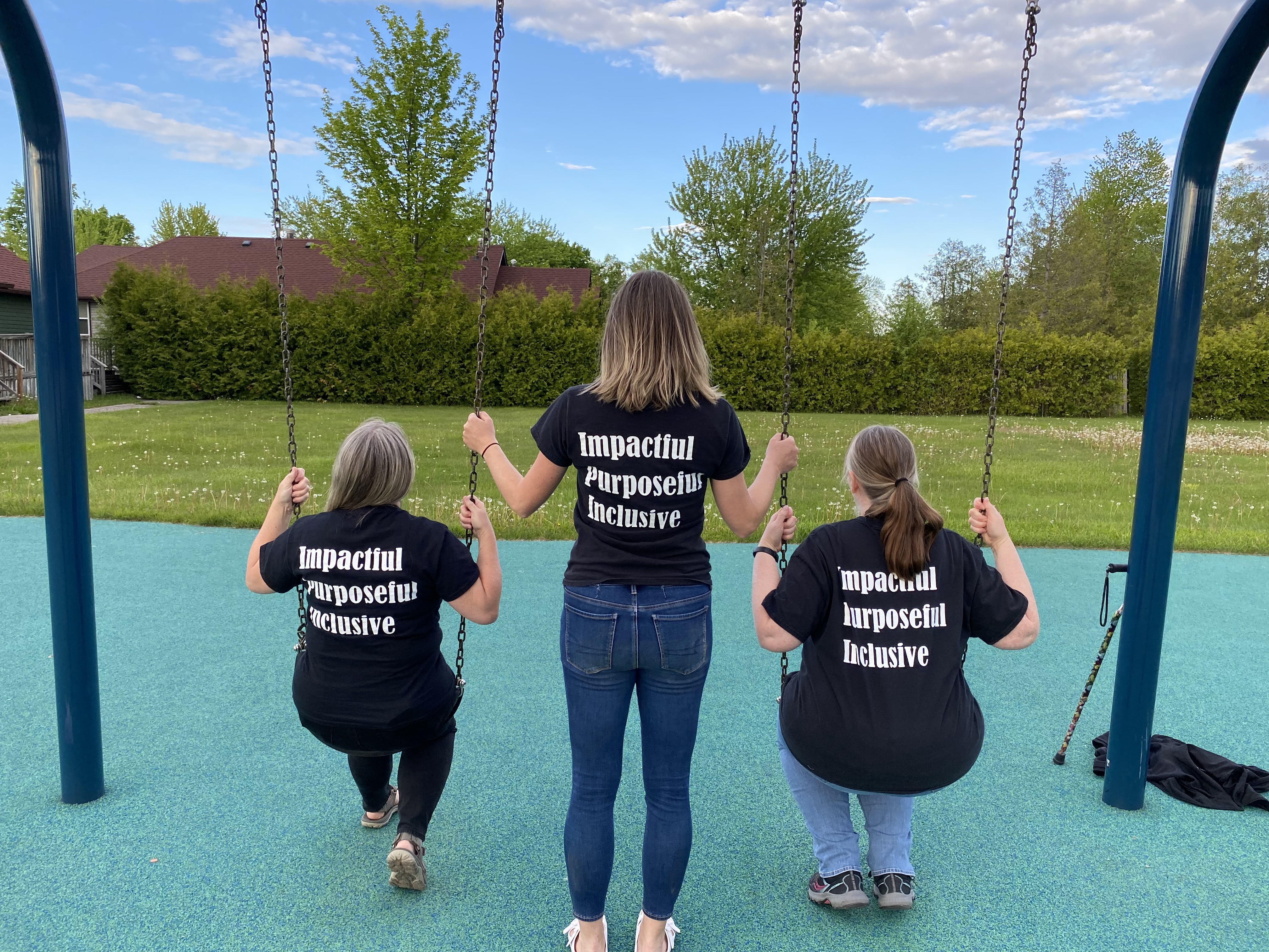 Our administration team enjoying swings on playground