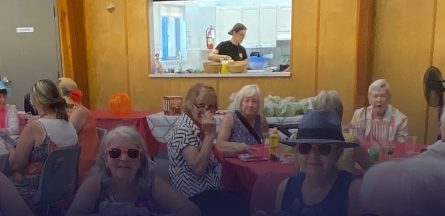 Seniors enjoying a free lunch with friends.