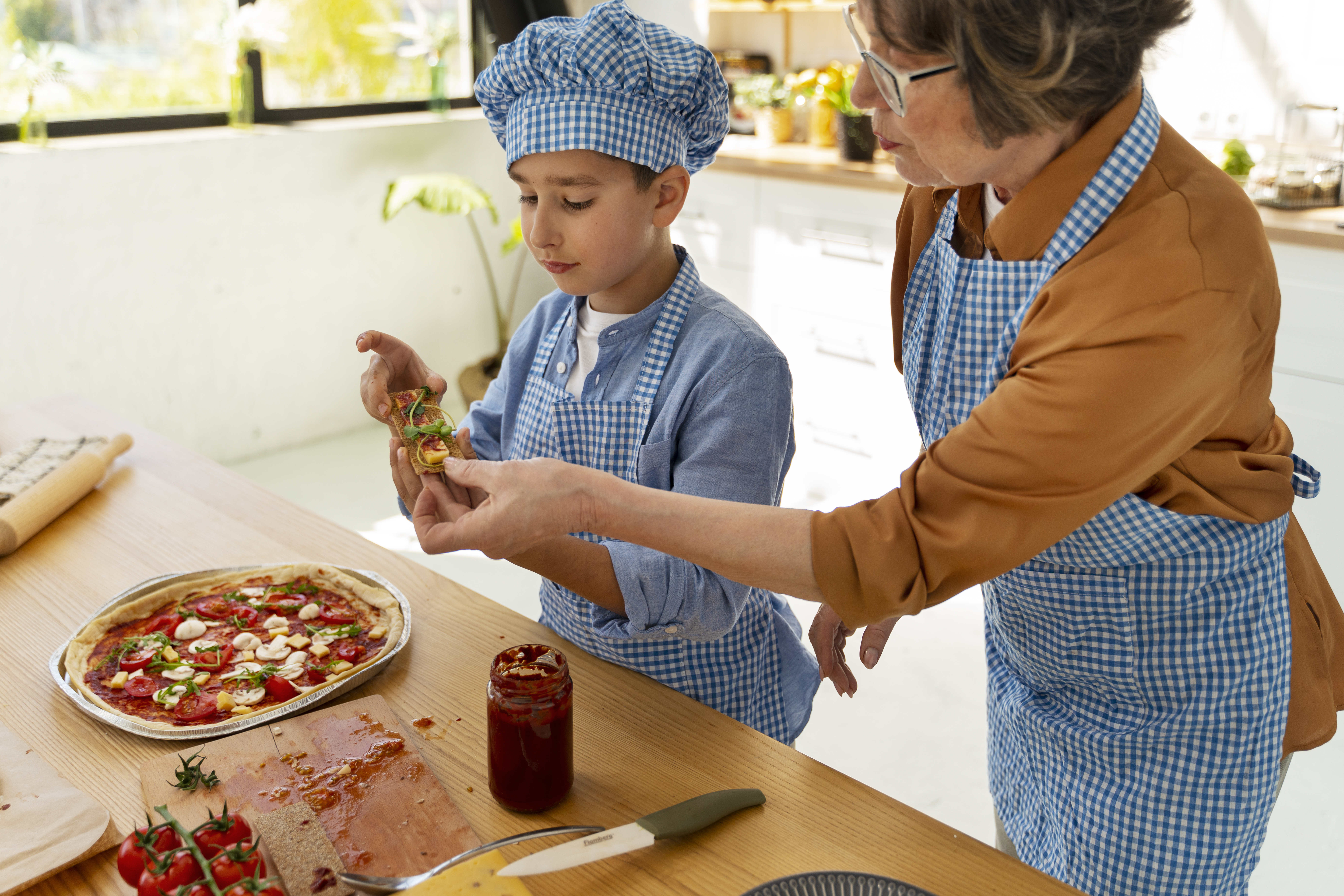 Adult working with child in kitchen