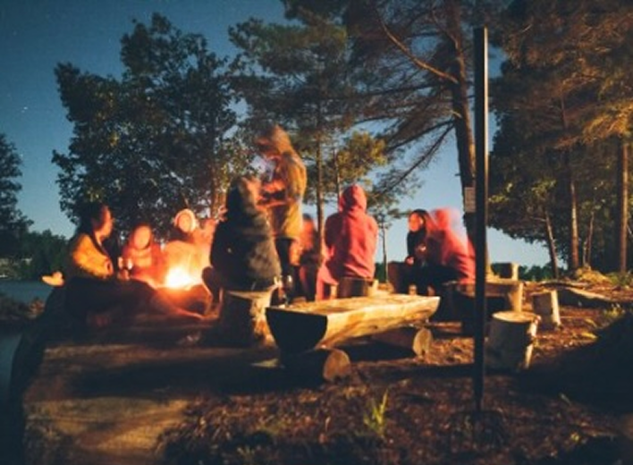 Group of campers around bonfire