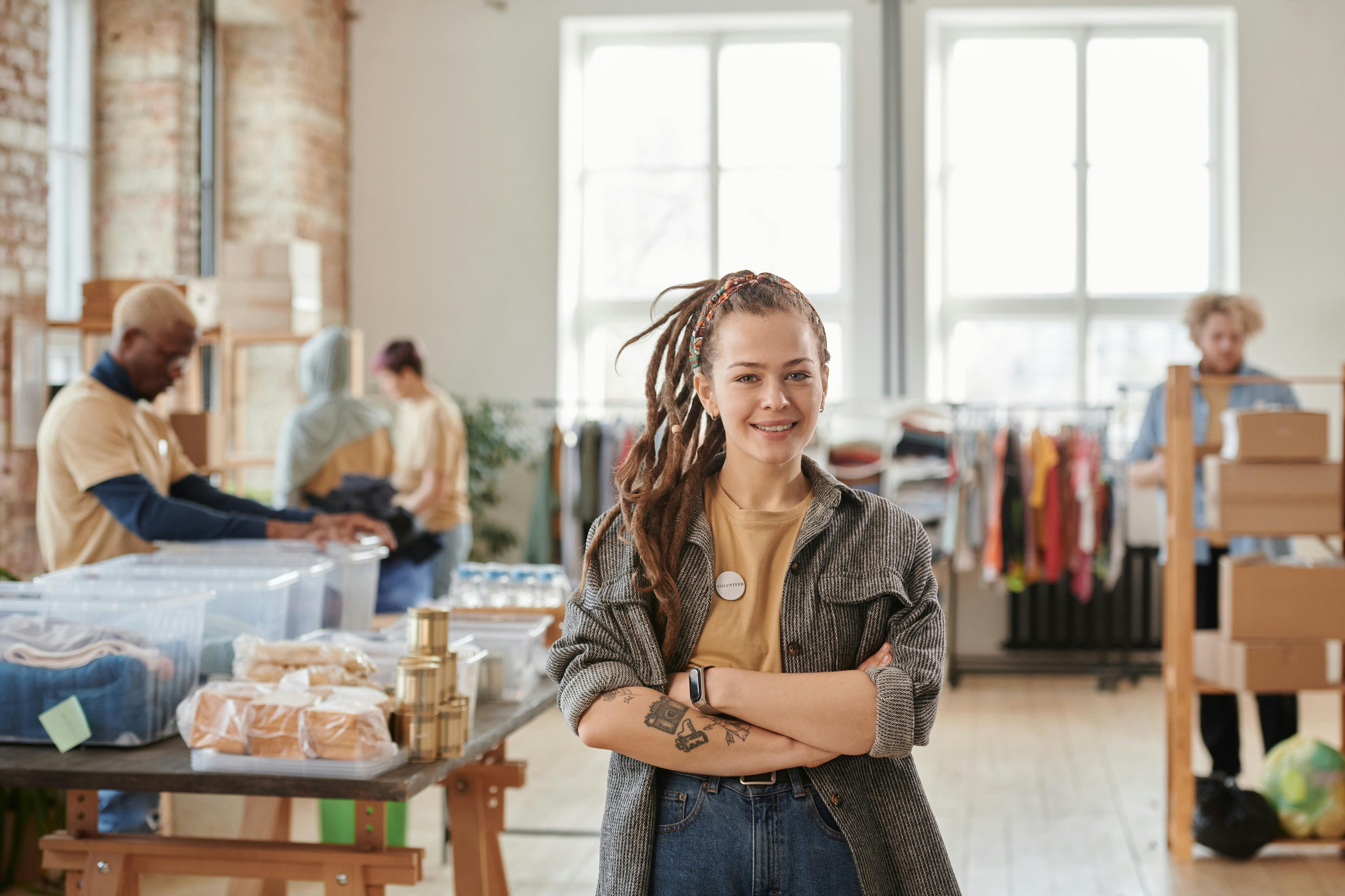 Female staff standing in thrift store.